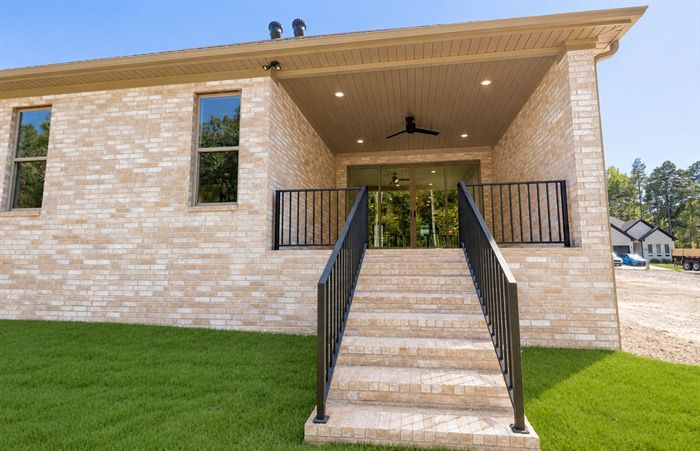 114 Kinley Loop — Covered rear porch with stone steps and iron railing