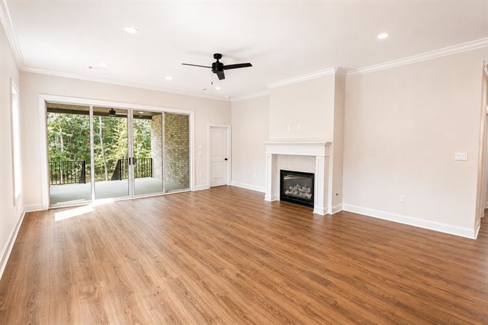 114 Kinley Loop — Living room with fireplace and sliding door to the porch