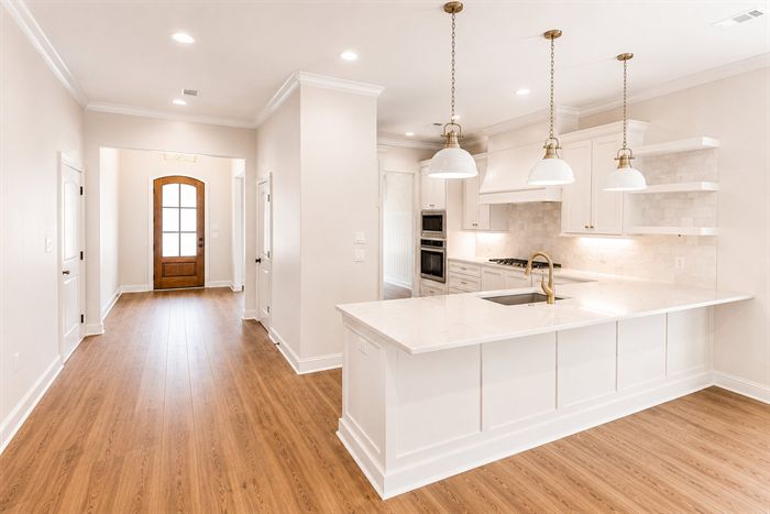 114 Kinley Loop — Kitchen island with pendant lighting and open shelving