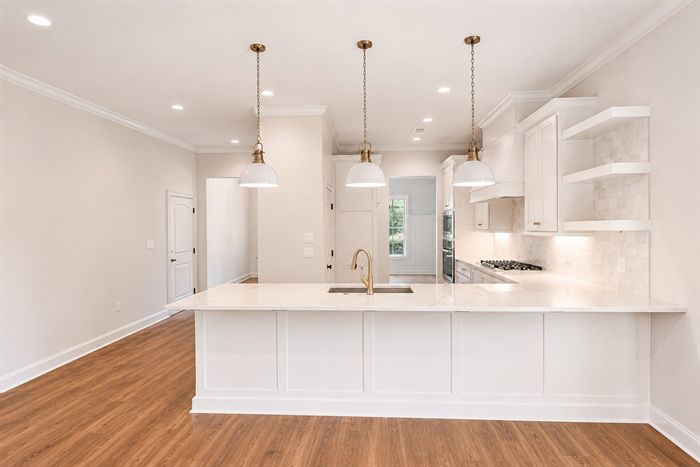 114 Kinley Loop — Kitchen island and gas range from the living room