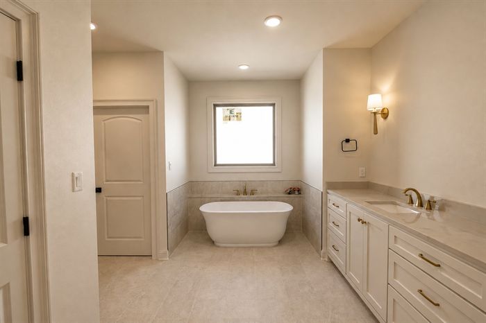 114 Kinley Loop — Primary bath soaking tub beside the vanity run