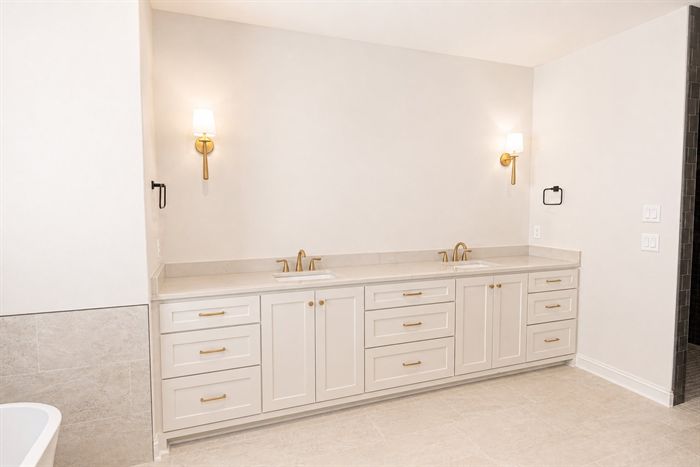 114 Kinley Loop — Vanity with brass sconces and brass fixtures
