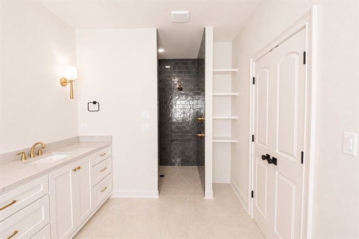 114 Kinley Loop — Bath vanity with view through to the tiled walk-in shower