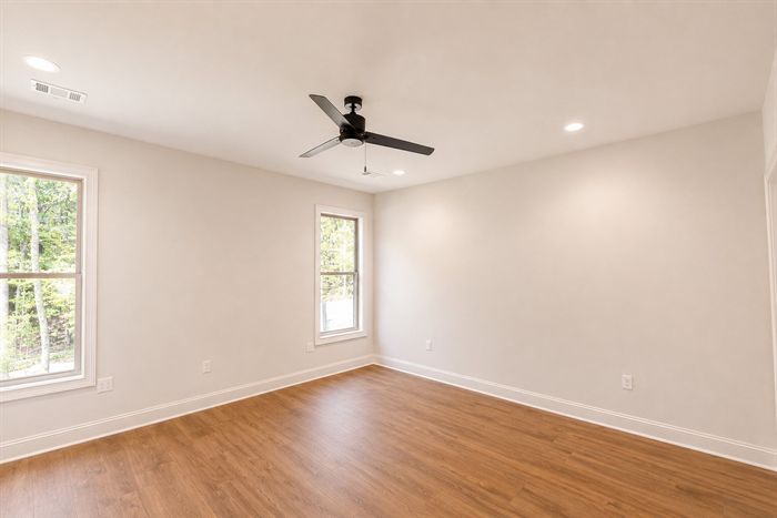 114 Kinley Loop — Bedroom with ceiling fan and wooded window view