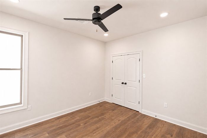 114 Kinley Loop — Bedroom with hardwood floors and natural light