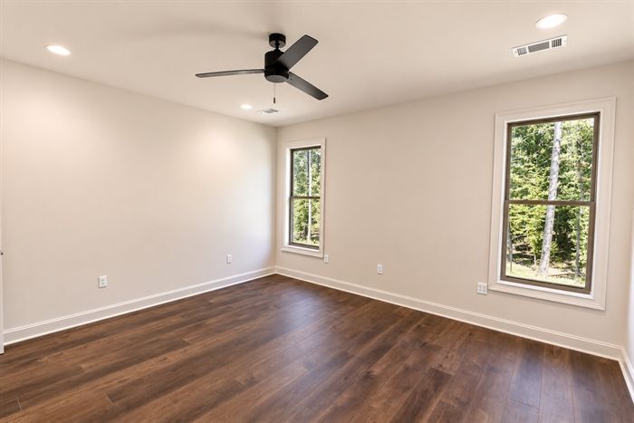 114 Kinley Loop — Bedroom with two windows overlooking the trees