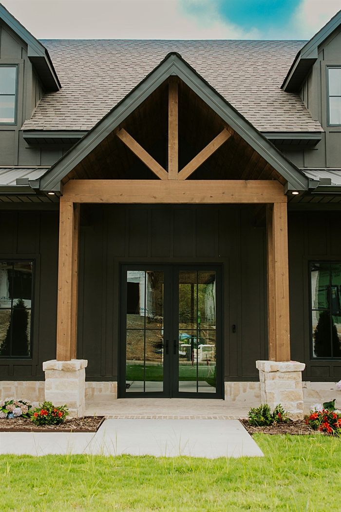 115 Bear Den Court &mdash; Covered entry with timber trusses and stone piers