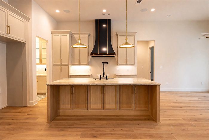 115 Bear Den Court &mdash; Kitchen with black range hood and white oak island