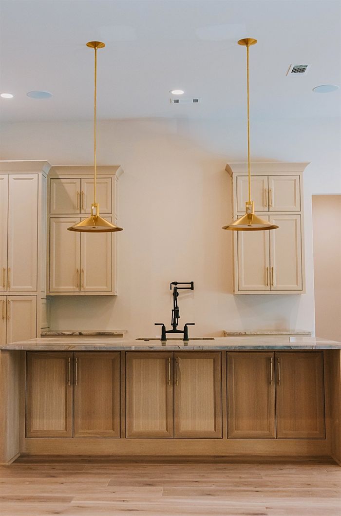 115 Bear Den Court &mdash; Island with brass pot filler and glass pendants