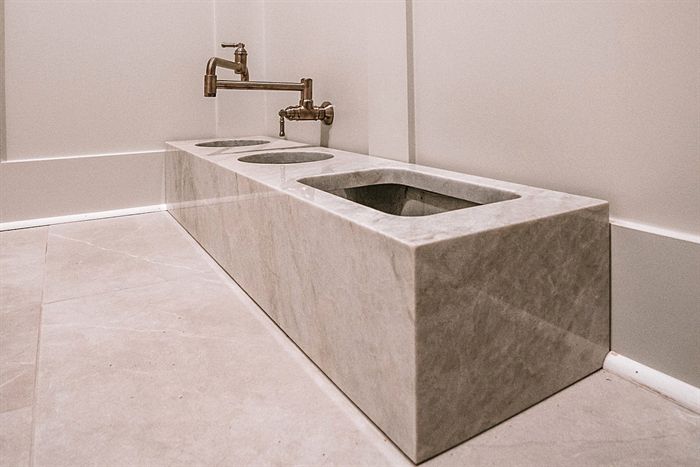 115 Bear Den Court &mdash; Stone utility sink with wall-mounted brass faucet