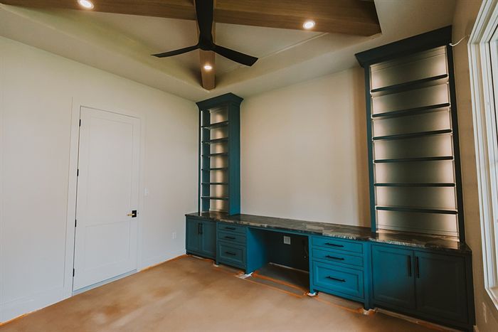 115 Bear Den Court &mdash; Study built-ins in deep teal with open shelving