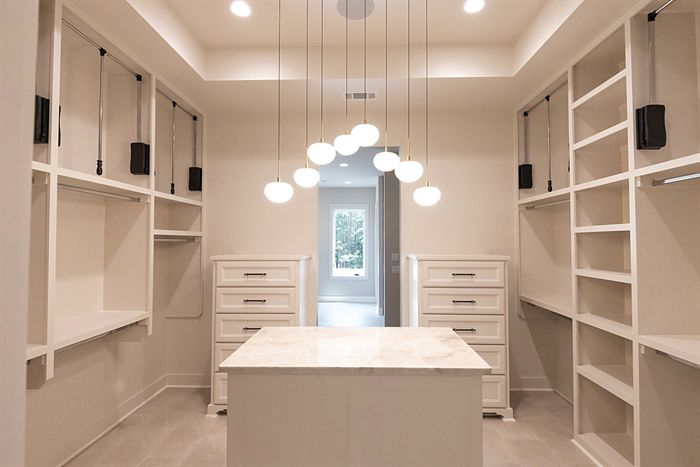 115 Bear Den Court &mdash; Primary closet with center island and globe chandelier