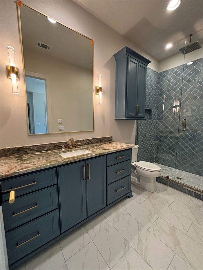 115 Bear Den Court &mdash; Guest bath with navy vanity and green tile shower