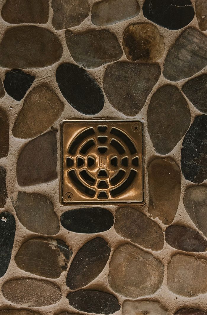 115 Bear Den Court &mdash; River rock shower floor with brass drain