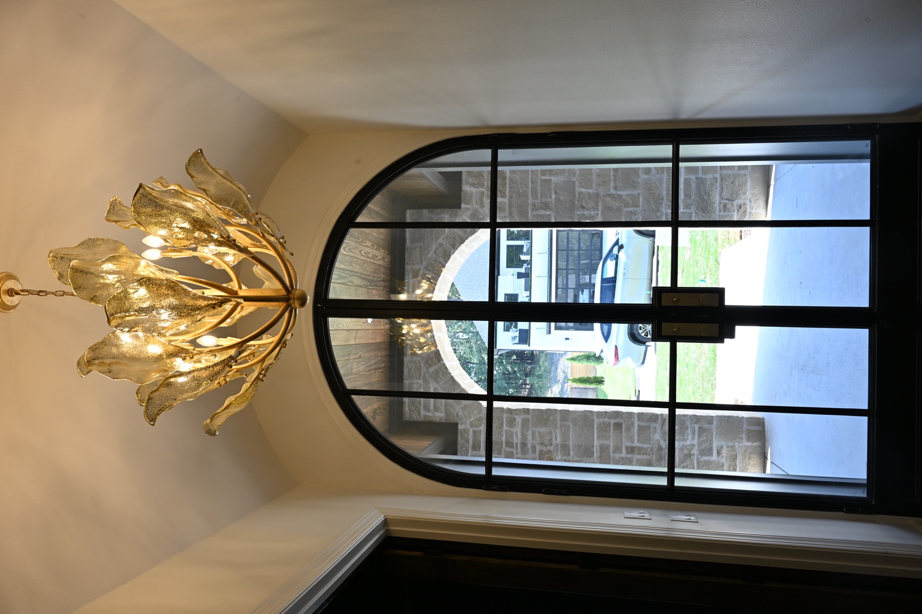 217 Abington Circle — Brass chandelier and arched window