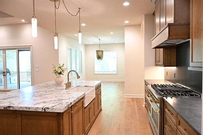 217 Abington Circle &mdash; Kitchen with marble island, brass faucet, and gas range