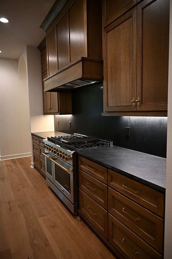 217 Abington Circle &mdash; Range wall with vent hood and honed stone counters