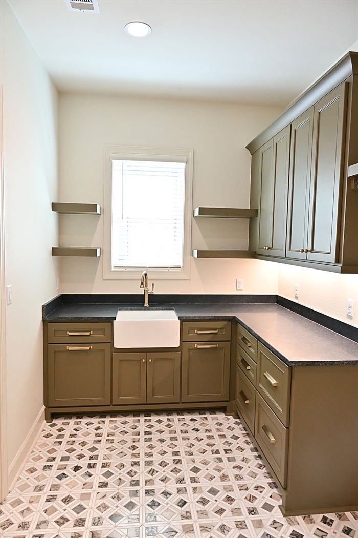 217 Abington Circle &mdash; Scullery with farmhouse sink and patterned tile floor