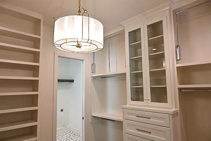 217 Abington Circle &mdash; Primary closet with painted built-ins and drum pendant