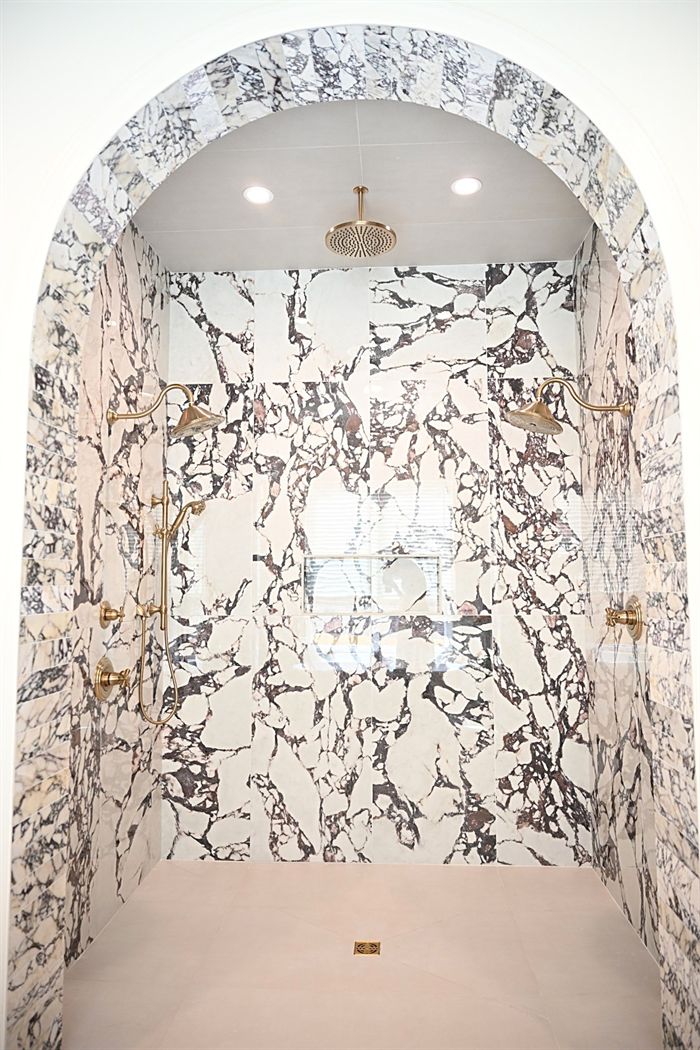 217 Abington Circle &mdash; Arched shower lined in book-matched marble