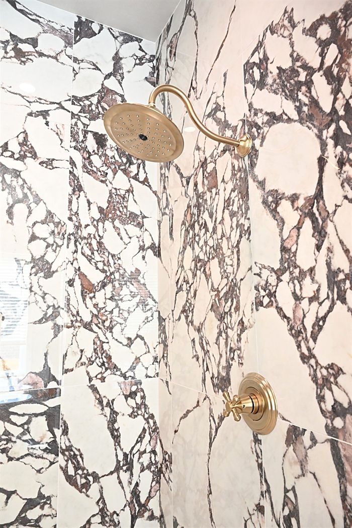 217 Abington Circle &mdash; Marble shower detail with unlacquered brass fittings