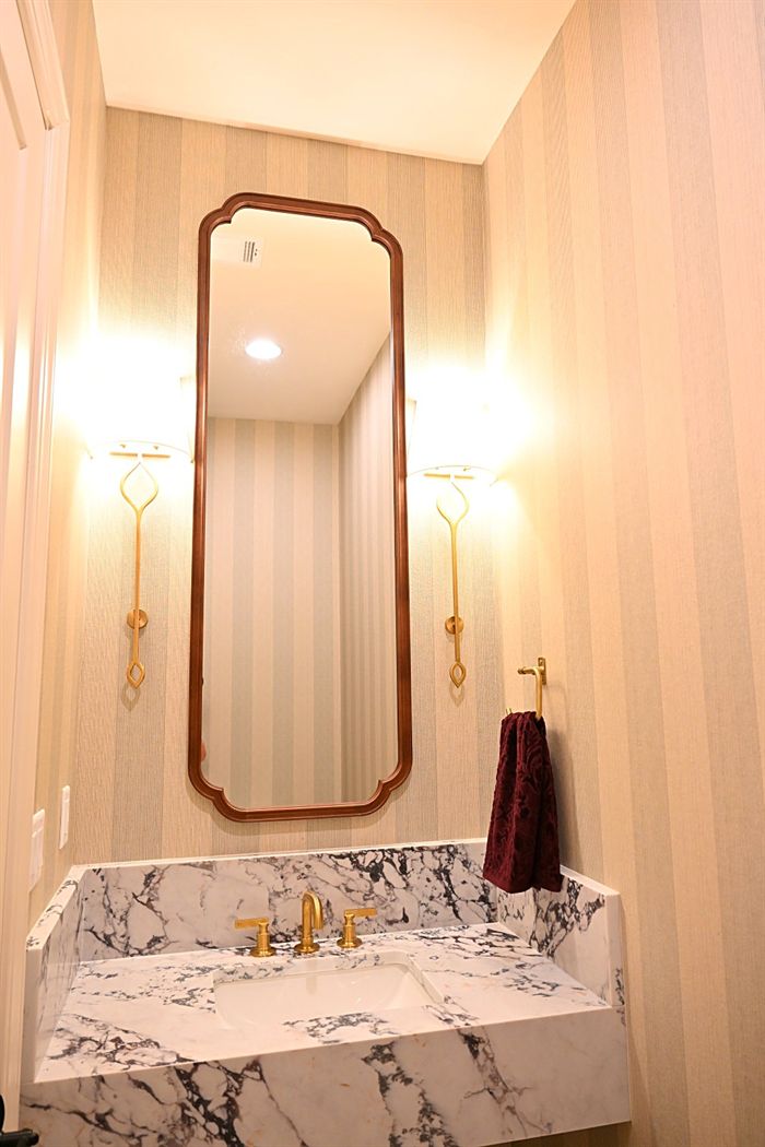 217 Abington Circle &mdash; Powder room with marble basin and brass mirror