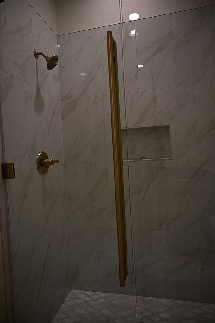 217 Abington Circle &mdash; Guest shower in marble with brass hardware