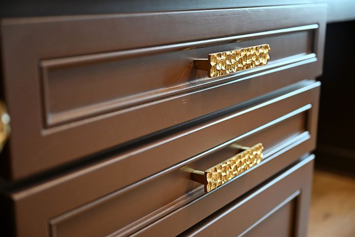 217 Abington Circle &mdash; Jeweled brass drawer pulls on stained cabinetry