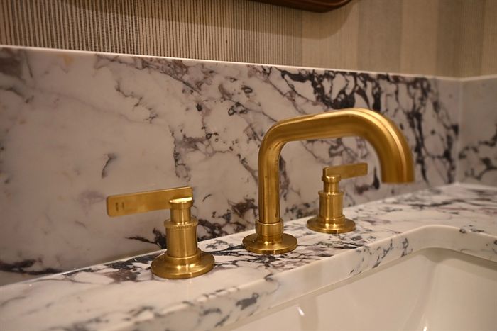 217 Abington Circle &mdash; Brass faucet against book-matched marble