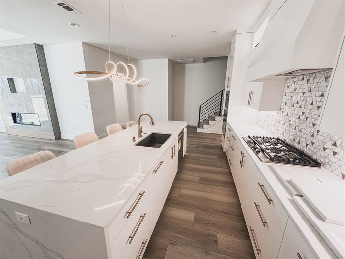 307 Fletcher Loop &mdash; Kitchen with waterfall quartz island and gas range